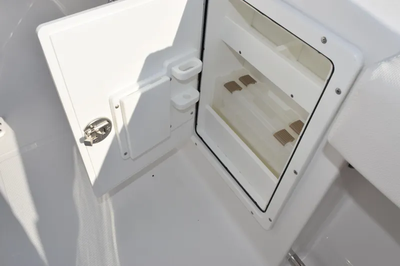 Slide: The Image of Storage compartment on 2026 Sea Hunt Ultra 265 SE boat, featuring secure latch and organized interior. - 17