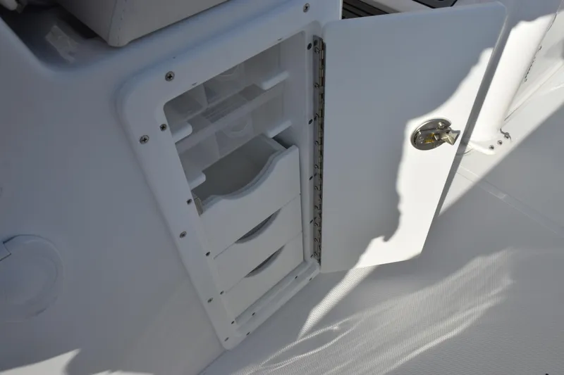 Slide: The Image of Open storage compartment on 2026 Sea Hunt Ultra 265 SE boat interior. - 18