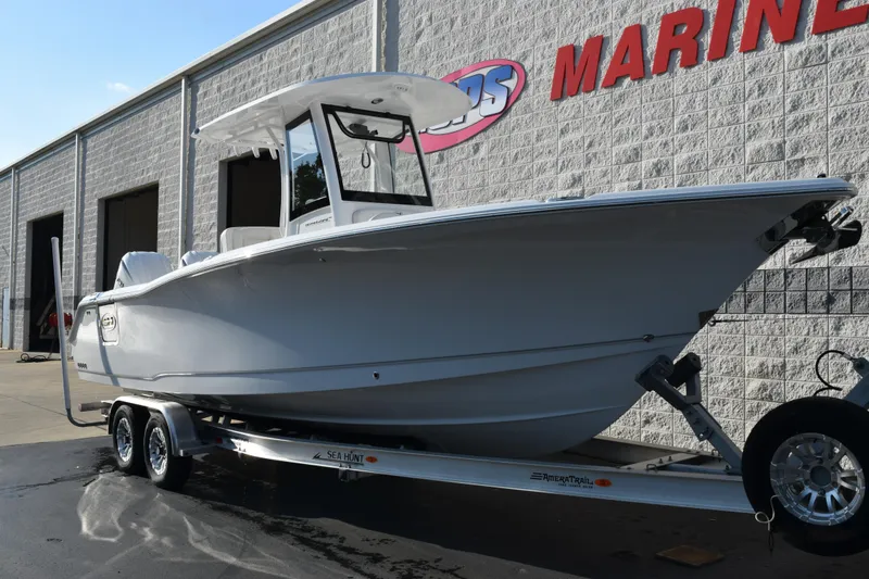 Slide: The Image of 2026 Sea Hunt Ultra 265 SE boat on trailer outside marine dealership. - 3