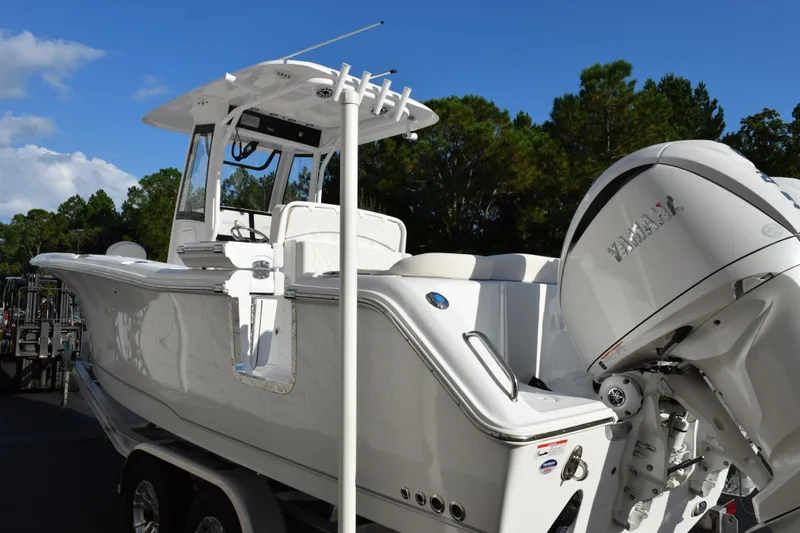 Slide: The Image of 2026 Sea Hunt Ultra 265 SE boat with Yamaha engine, parked outdoors. - 6
