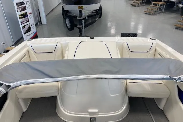 Slide: The Image of 2012 Bayliner 195 Discovery boat interior with seating and covered engine compartment. - 15