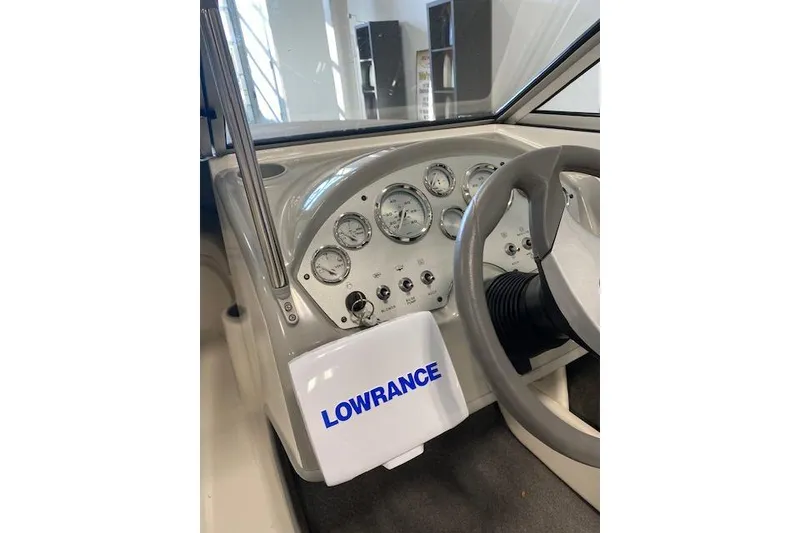 Slide: The Image of 2012 Bayliner 195 Discovery dashboard with Lowrance equipment and steering wheel. - 5