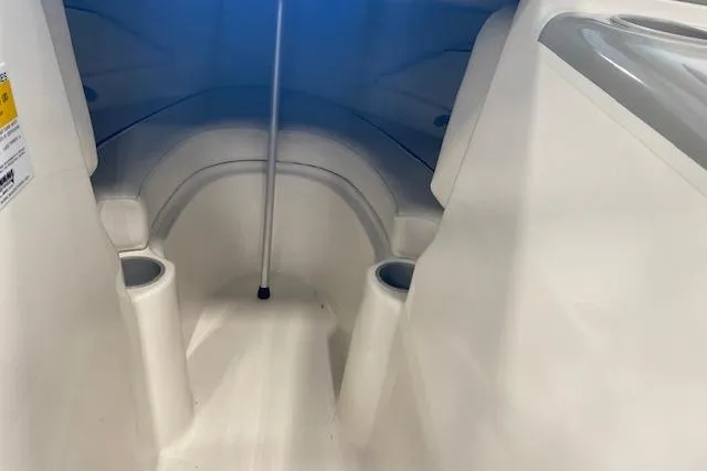 Slide: The Image of Interior view of 2012 Bayliner 195 Discovery boat cabin with seating and cup holders. - 6