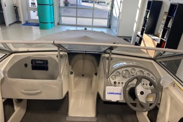 Slide: The Image of 2012 Bayliner 195 Discovery boat interior with steering wheel and dashboard controls. - 8