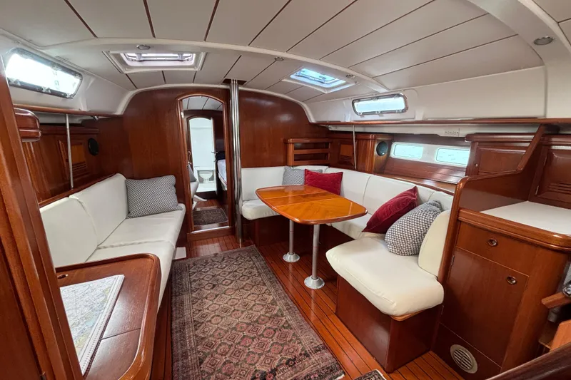 Slide: The Image of Luxurious interior of 2002 Beneteau Oceanis 411 yacht with elegant wood finish and cozy seating. - 18