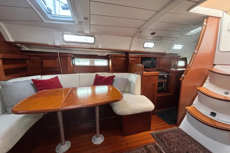 Slide: The Image of Luxurious 2002 Beneteau Oceanis 411 yacht interior with elegant wood finish and cozy seating. - 26