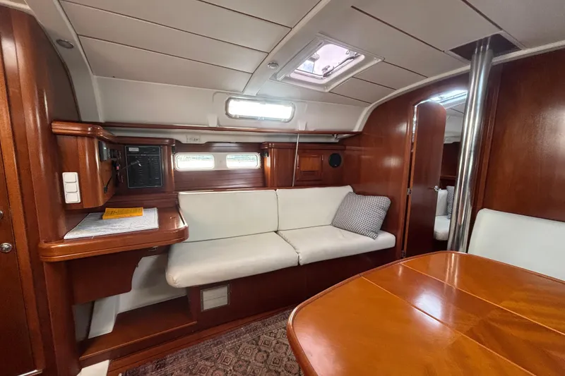 Slide: The Image of Interior of 2002 Beneteau Oceanis 411 yacht with wooden finish and white seating. - 3