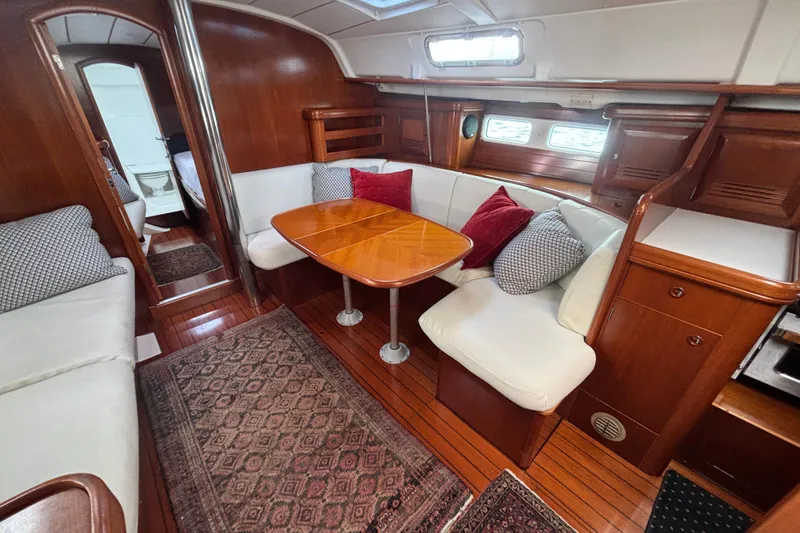 Slide: The Image of Luxurious interior of 2002 Beneteau Oceanis 411 sailboat with cozy seating and wooden finishes. - 30