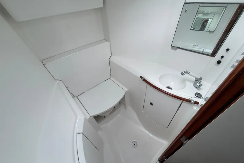 Slide: The Image of Compact bathroom in 2002 Beneteau Oceanis 411 yacht with sink, mirror, and storage. - 34