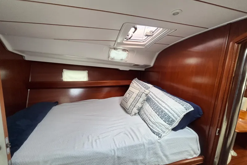 Slide: The Image of Cozy cabin interior of 2002 Beneteau Oceanis 411 sailboat with bed and wooden finish. - 35