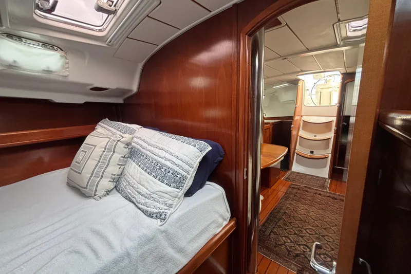 Slide: The Image of Interior of 2002 Beneteau Oceanis 411 sailboat with cozy cabin and wooden finish. - 36