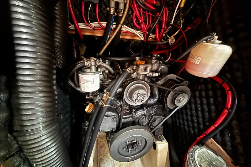 Slide: The Image of Engine compartment of a 2002 Beneteau Oceanis 411 sailboat, showing detailed wiring and components. - 39