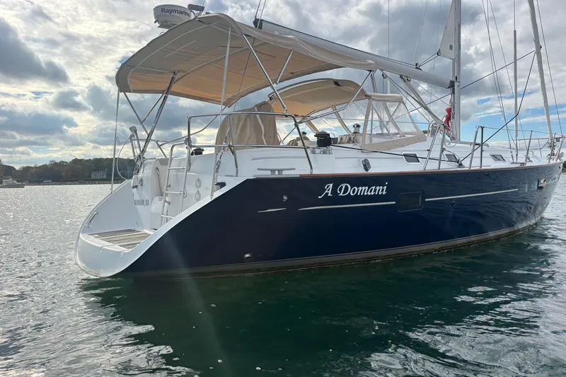 Slide: The Image of 2002 Beneteau Oceanis 411 sailboat on water, featuring sleek design and spacious deck. - 7