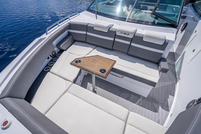 Slide: The Image of 2022 Cruisers Yachts 38 GLS OB interior with seating and table on water. - 12