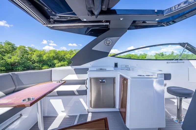 Slide: The Image of 2022 Cruisers Yachts 38 GLS OB interior with sleek seating and modern amenities. - 30