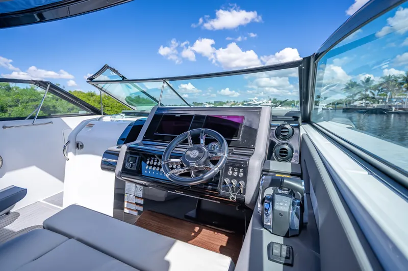 Slide: The Image of 2022 Cruisers Yachts 38 GLS OB helm with modern controls and panoramic view. - 21