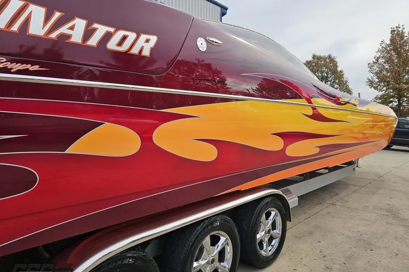 Slide: The Image of 2008 Eliminator 36 Daytona Coupe with vibrant flame graphics on a trailer. - 15