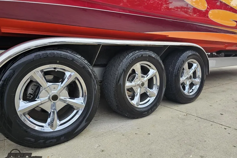 Slide: The Image of 2008 Eliminator 36 Daytona Coupe trailer with chrome wheels and vibrant red-orange design. - 17