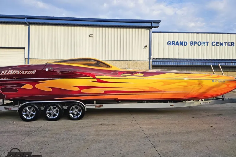 Slide: The Image of 2008 Eliminator 36 Daytona Coupe with vibrant flame design at Grand Sport Center. - 2