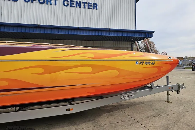 Slide: The Image of 2008 Eliminator 36 Daytona Coupe with vibrant flame design on trailer. - 21