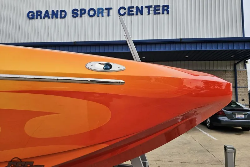 Slide: The Image of 2008 Eliminator 36 Daytona Coupe boat at Grand Sport Center, vibrant orange and yellow design. - 22