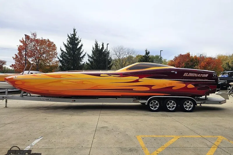 Slide: The Image of 2008 Eliminator 36 Daytona Coupe boat with vibrant flame design on a trailer. - 29