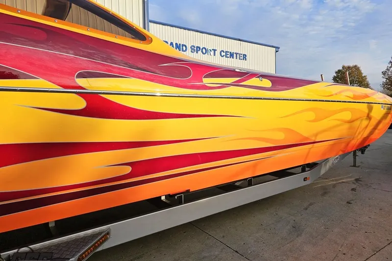 Slide: The Image of 2008 Eliminator 36 Daytona Coupe with vibrant flame graphics on trailer. - 3