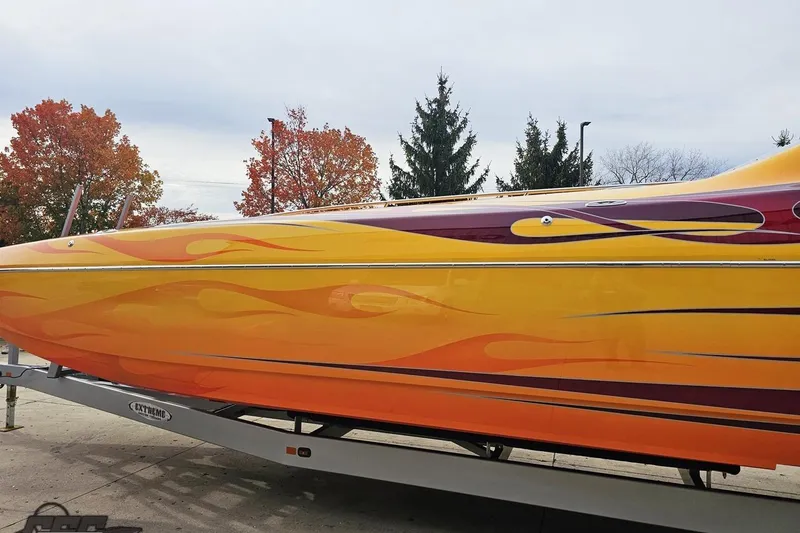 Slide: The Image of 2008 Eliminator 36 Daytona Coupe with vibrant flame design on trailer. - 30