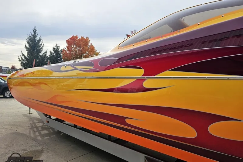 Slide: The Image of 2008 Eliminator 36 Daytona Coupe with vibrant flame graphics on the side. - 32