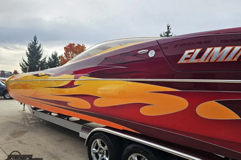 Slide: The Image of 2008 Eliminator 36 Daytona Coupe with vibrant flame design on trailer. - 33
