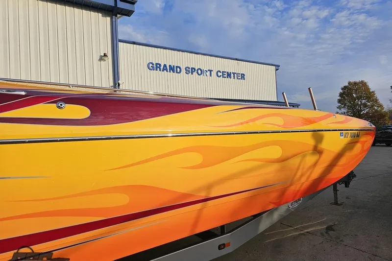 Slide: The Image of 2008 Eliminator 36 Daytona Coupe with vibrant flame design at Grand Sport Center. - 4