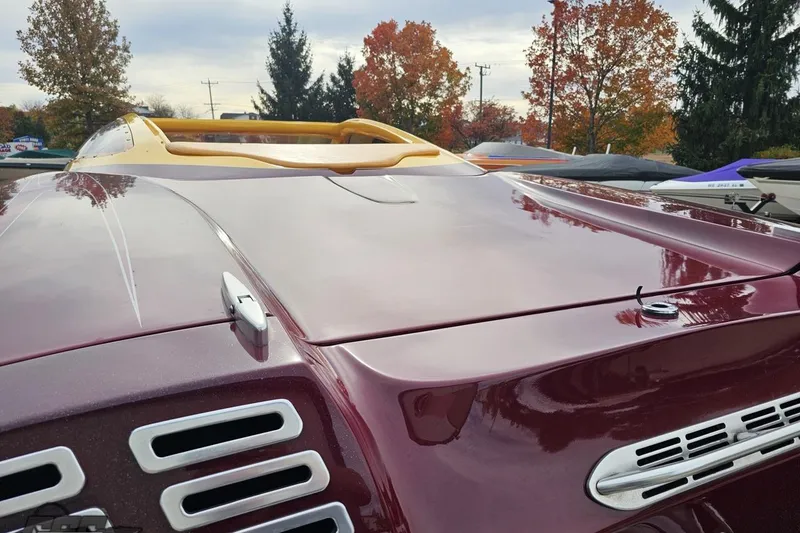 Slide: The Image of 2008 Eliminator 36 Daytona Coupe boat with sleek maroon finish and aerodynamic design. - 44