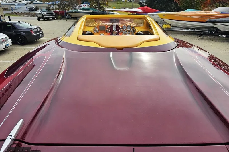 Slide: The Image of 2008 Eliminator 36 Daytona Coupe with sleek maroon finish and detailed cockpit view. - 46