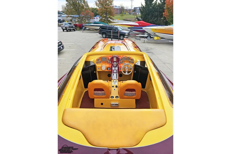 Slide: The Image of 2008 Eliminator 36 Daytona Coupe cockpit with vibrant yellow and orange interior design. - 48