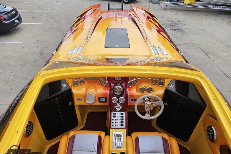 Slide: The Image of 2008 Eliminator 36 Daytona Coupe boat interior with vibrant yellow and red design. - 51