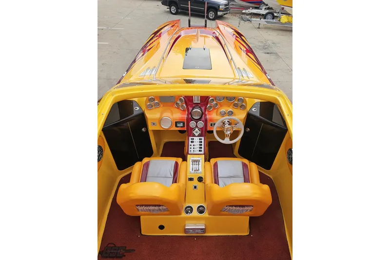 Slide: The Image of 2008 Eliminator 36 Daytona Coupe cockpit with vibrant yellow and red interior design. - 52