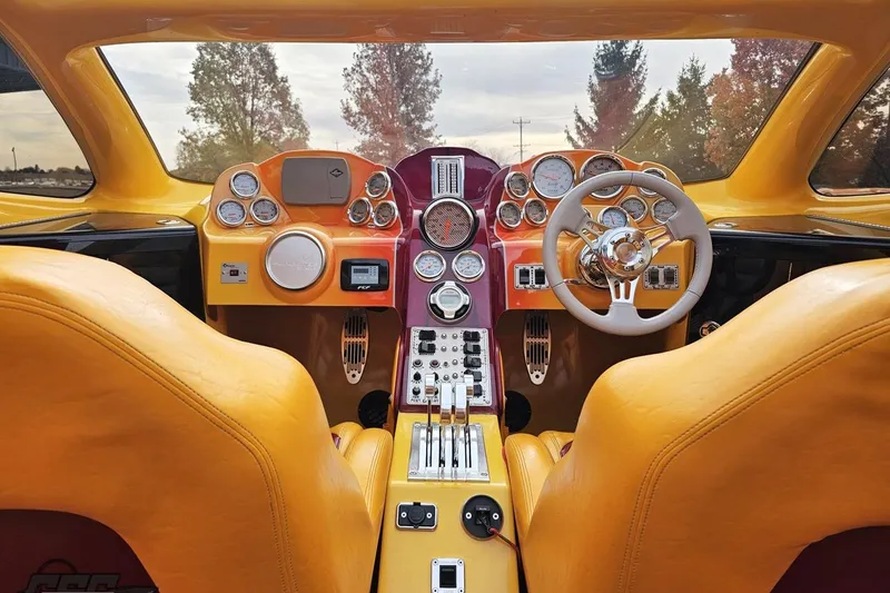 Slide: The Image of Interior of a 2008 Eliminator 36 Daytona Coupe with vibrant yellow and orange design. - 54