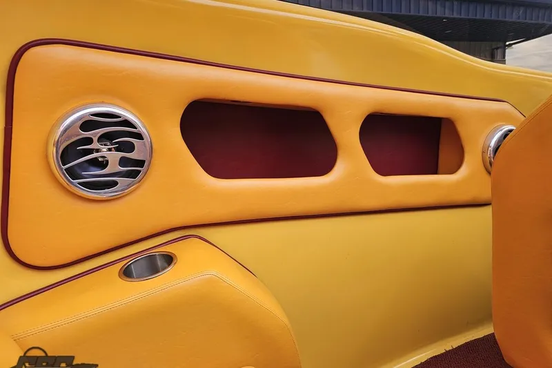 Slide: The Image of Yellow and red interior of 2008 Eliminator 36 Daytona Coupe with speaker and cup holder. - 55