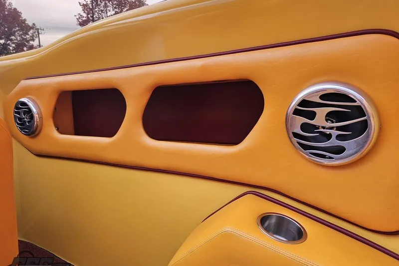 Slide: The Image of 2008 Eliminator 36 Daytona Coupe interior with yellow and orange accents, featuring custom air vents. - 56