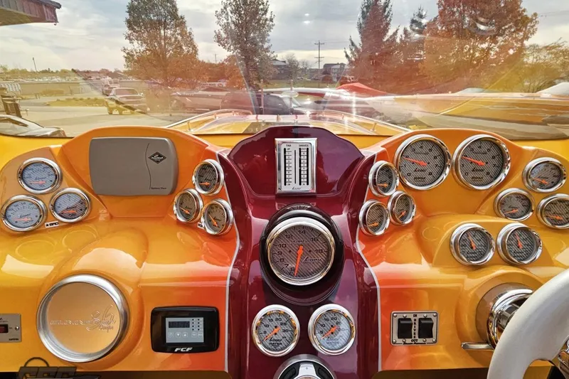 Slide: The Image of Dashboard of a 2008 Eliminator 36 Daytona Coupe with multiple gauges and vibrant colors. - 58