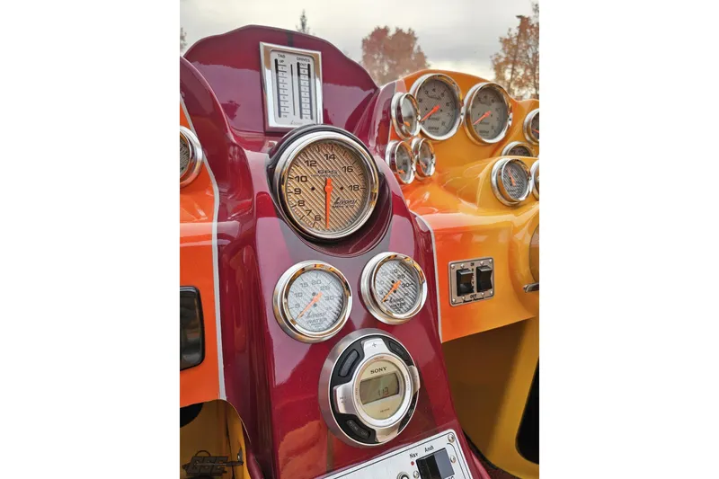Slide: The Image of Dashboard of a 2008 Eliminator 36 Daytona Coupe with multiple gauges and controls. - 60
