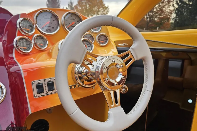 Slide: The Image of 2008 Eliminator 36 Daytona Coupe dashboard with white steering wheel and multiple gauges. - 61