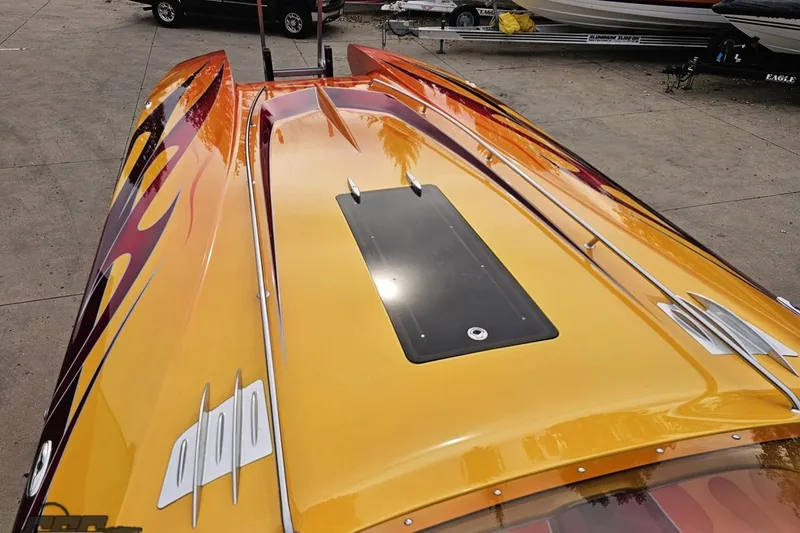 Slide: The Image of 2008 Eliminator 36 Daytona Coupe with vibrant flame design on deck. - 63