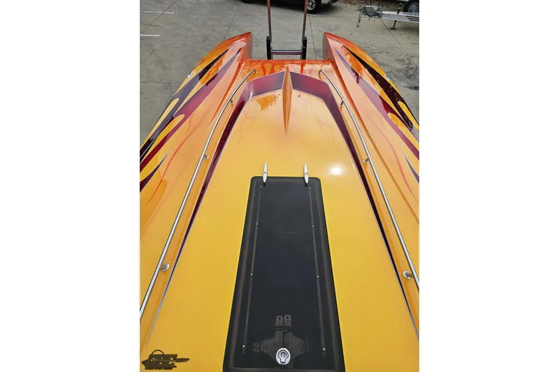 Slide: The Image of 2008 Eliminator 36 Daytona Coupe with vibrant orange and yellow flame design. - 66