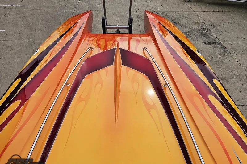 Slide: The Image of 2008 Eliminator 36 Daytona Coupe with vibrant orange and yellow flame design. - 67
