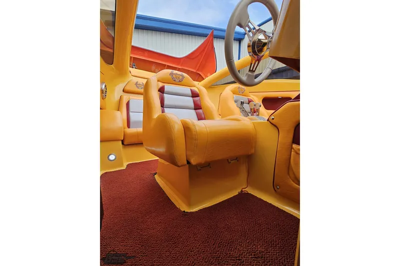 Slide: The Image of 2008 Eliminator 36 Daytona Coupe interior with vibrant orange and red upholstery. - 70