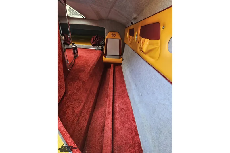Slide: The Image of Interior of 2008 Eliminator 36 Daytona Coupe with red carpet and yellow accents. - 73