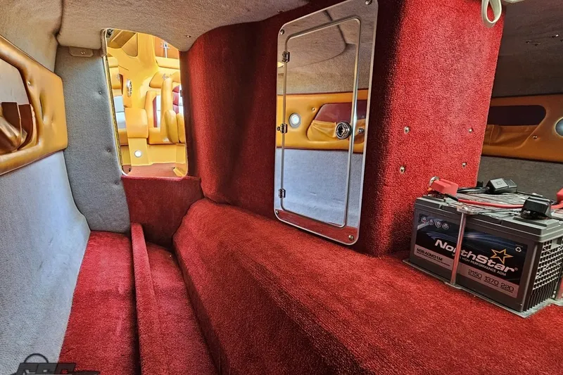 Slide: The Image of 2008 Eliminator 36 Daytona Coupe interior with red carpet and NorthStar battery. - 76