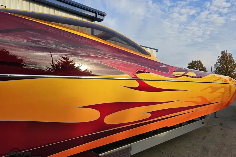 Slide: The Image of 2008 Eliminator 36 Daytona Coupe with vibrant flame graphics under a blue sky. - 8