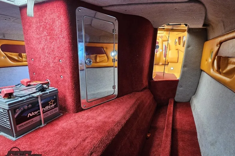 Slide: The Image of Interior of 2008 Eliminator 36 Daytona Coupe with red carpet and NorthStar battery. - 84